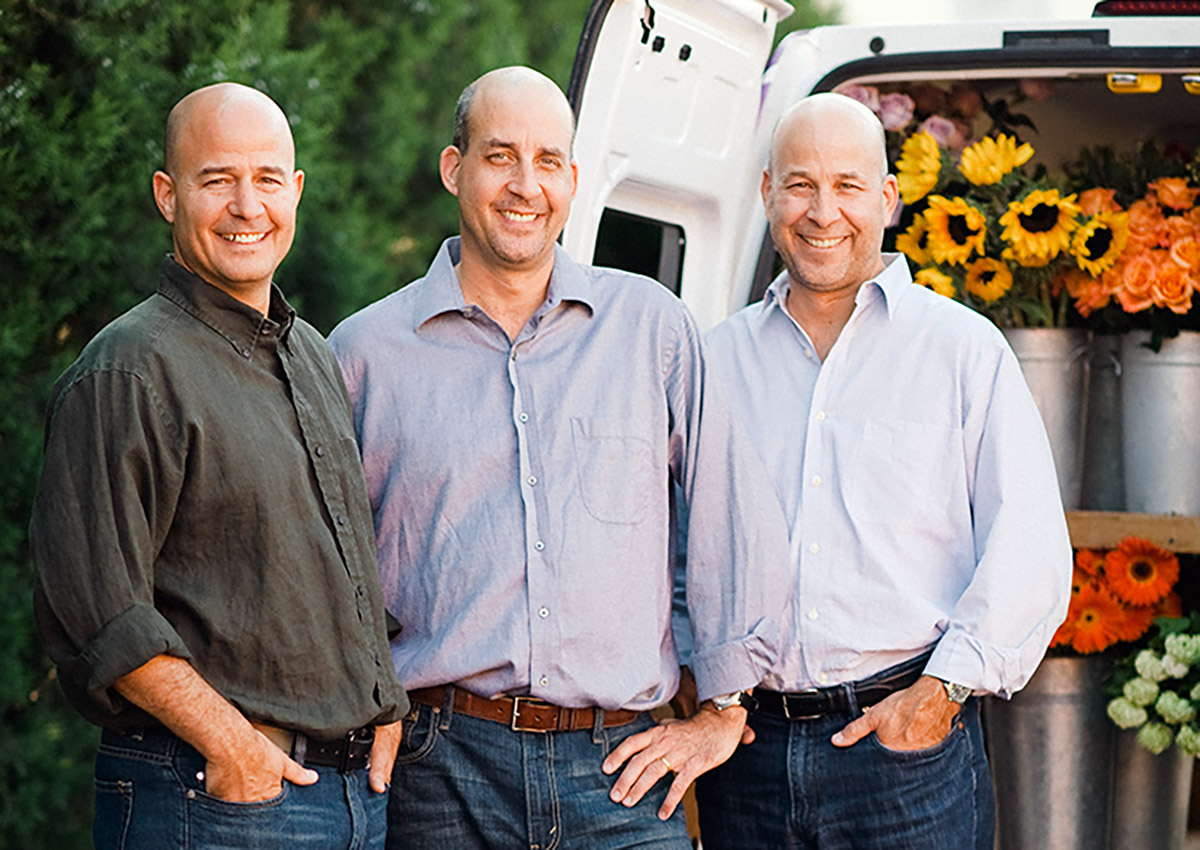 Our three-man management team, visiting outside a well-stocked delivery van